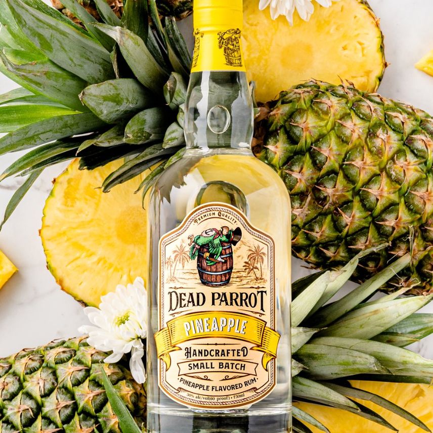 Bottle of rum on a bed of pineapples